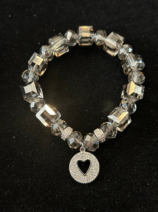 Crystal bracelet with silver plates round heart charm